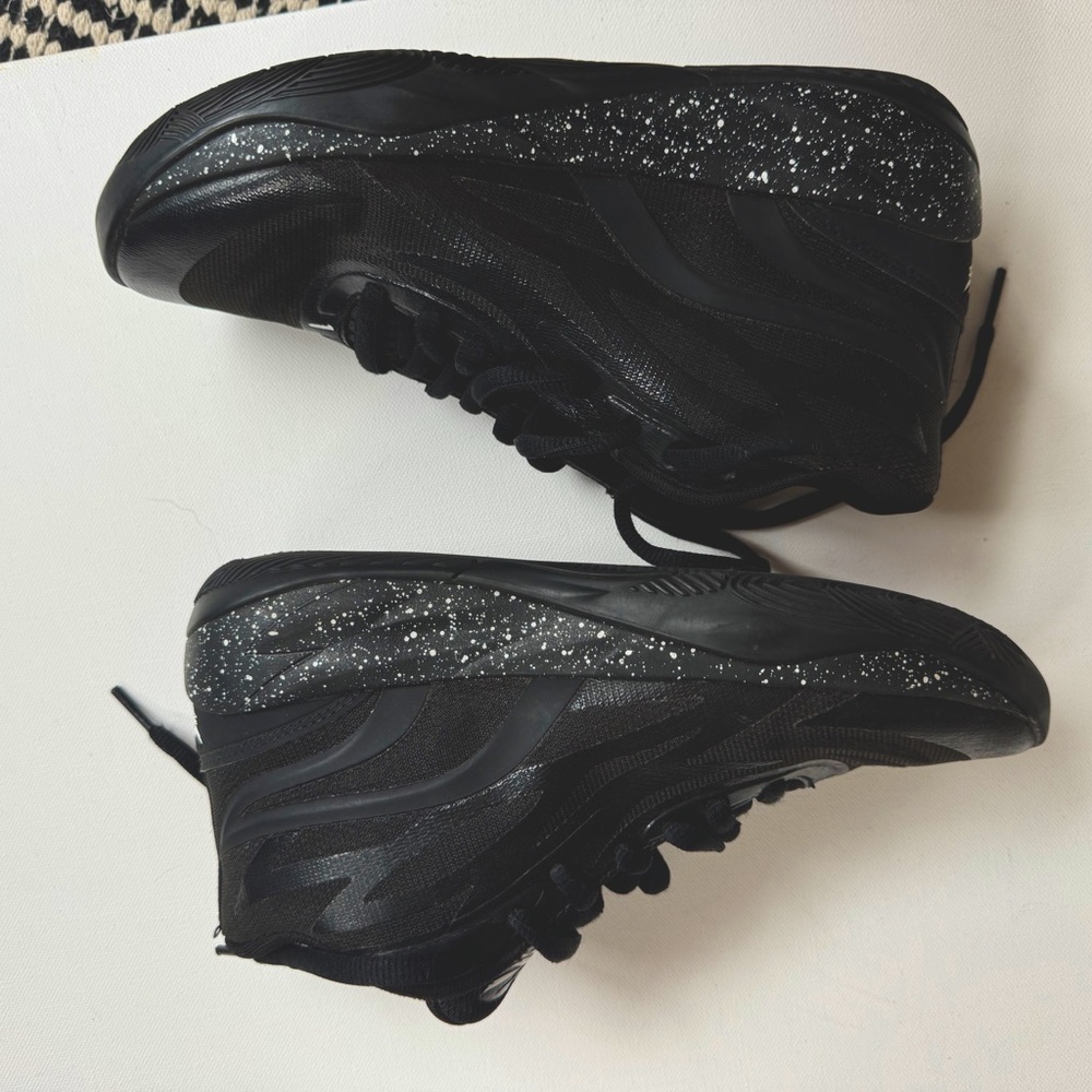 Kid size 5 1/2 Puma M.E.L.O shoes in black.